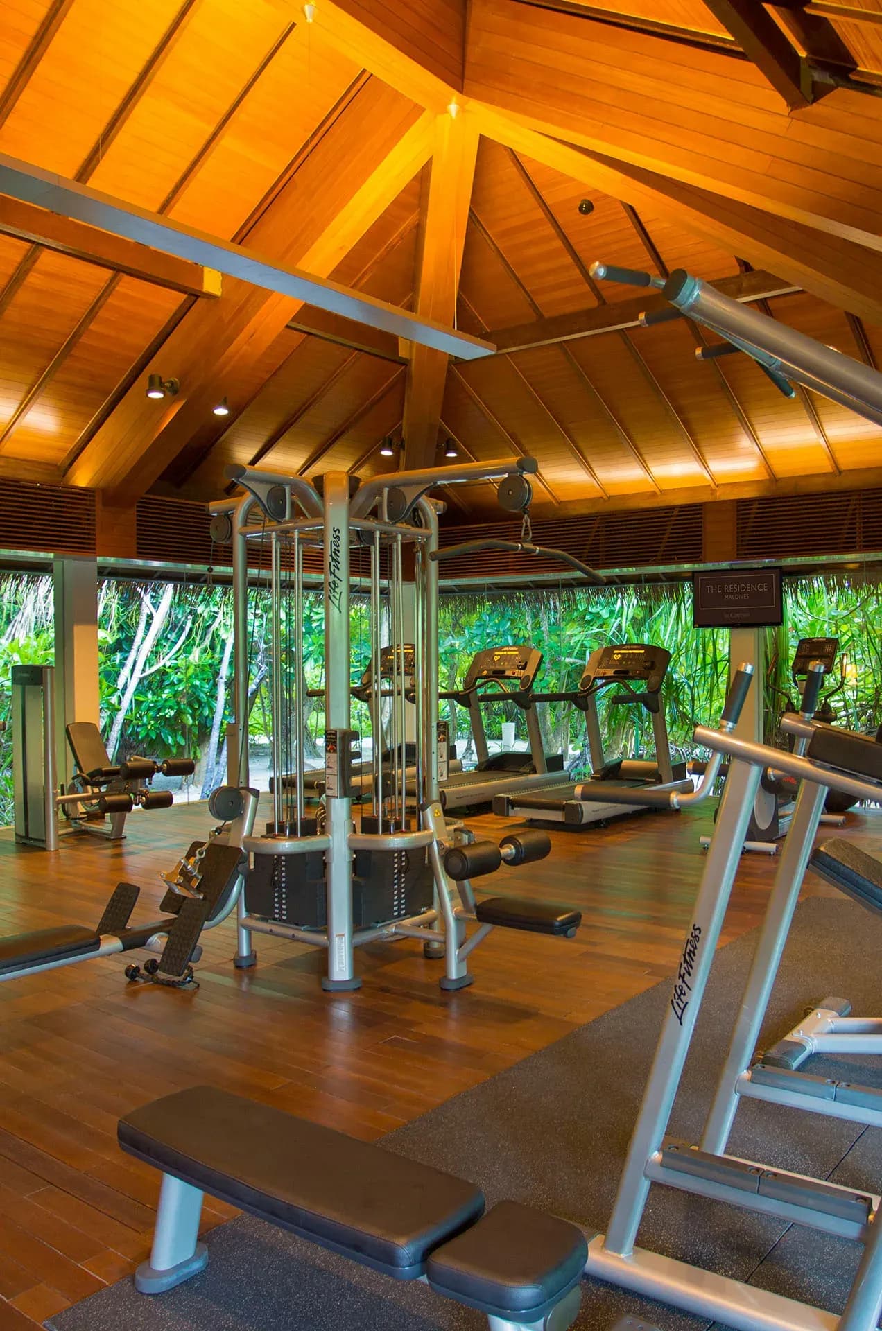 Open-air fitness centre with cardio and weight equipment overlooking the gardens, The Residence Maldives at Falhumaafushi