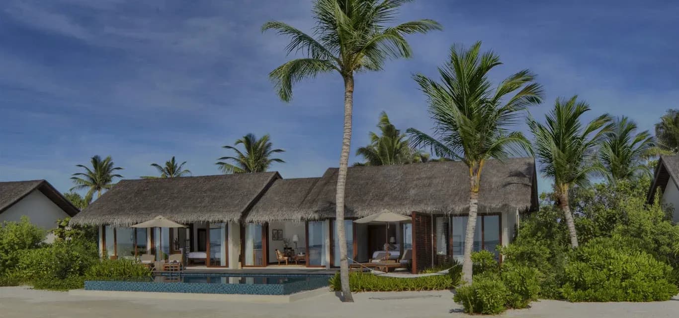 Two-Bedroom Beach Pool Villa exterior among palm trees, The Residence Maldives at Falhumaafushi