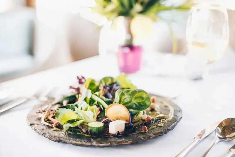 Plated salad course at the restaurant table at Tulia Zanzibar