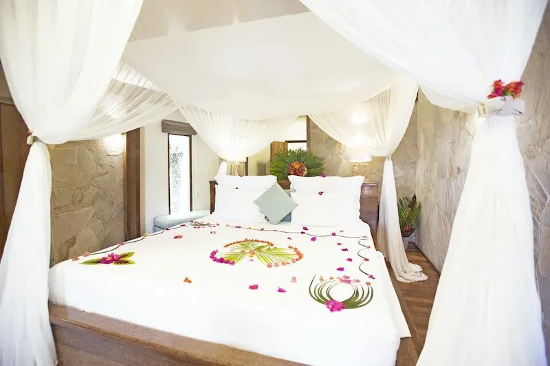 Four-poster bed in a Deluxe Garden Bungalow at Tulia Zanzibar