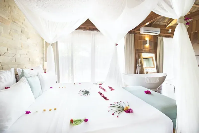 Bedroom and freestanding bathtub in the Royal Garden Villa with Private Pool at Tulia Zanzibar