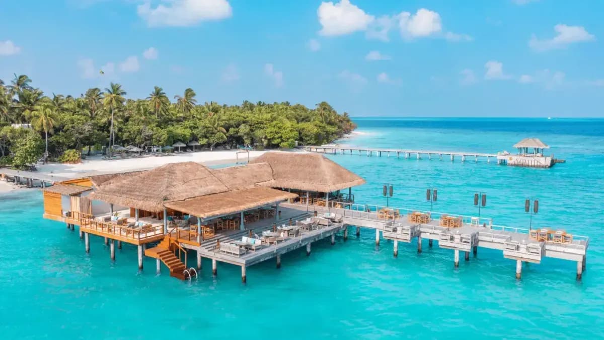 Lagoon Bar overwater dining deck at sunset, Vakkaru Maldives