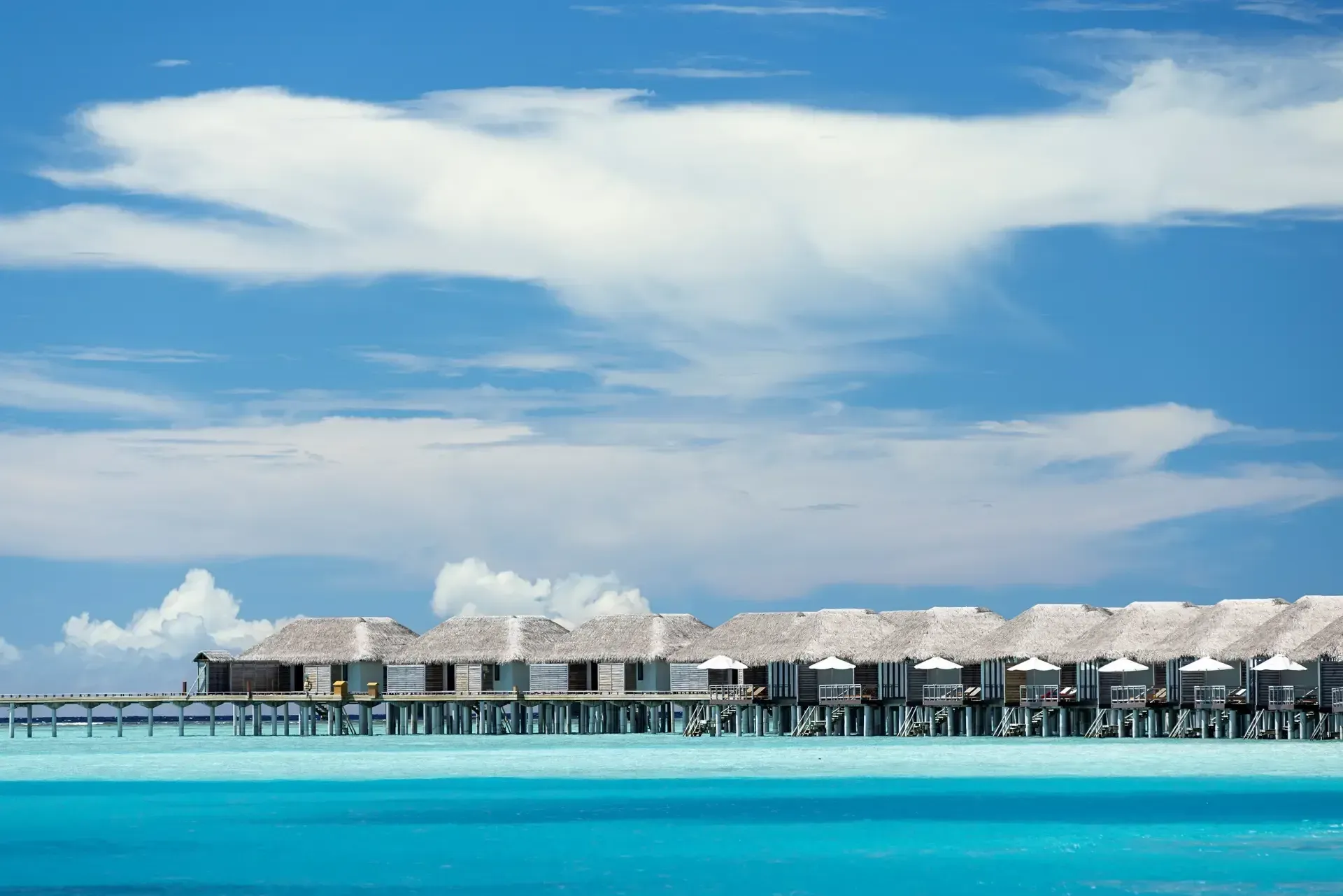 Aerial view of overwater villas and the turquoise lagoon at Niva Velassaru Maldives