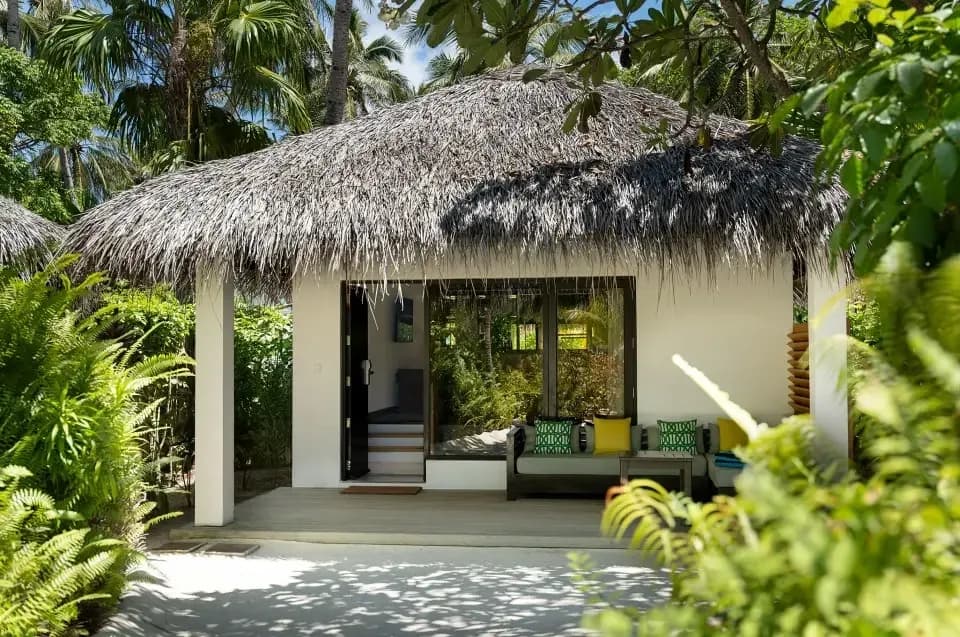 Deluxe Villa garden exterior with tropical planting at Niva Velassaru Maldives