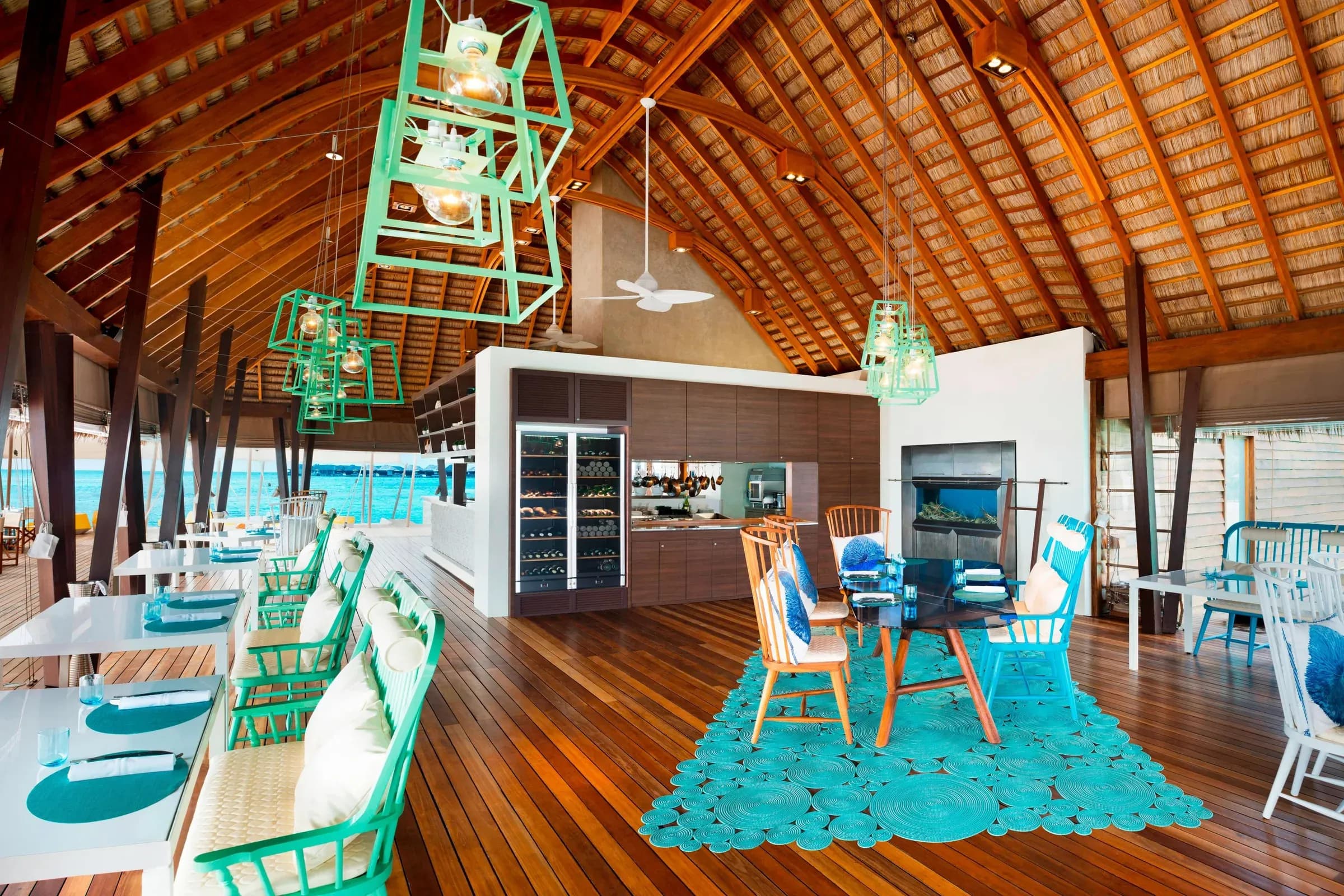 Interior dining setting at FISH, W Maldives' overwater seafood restaurant
