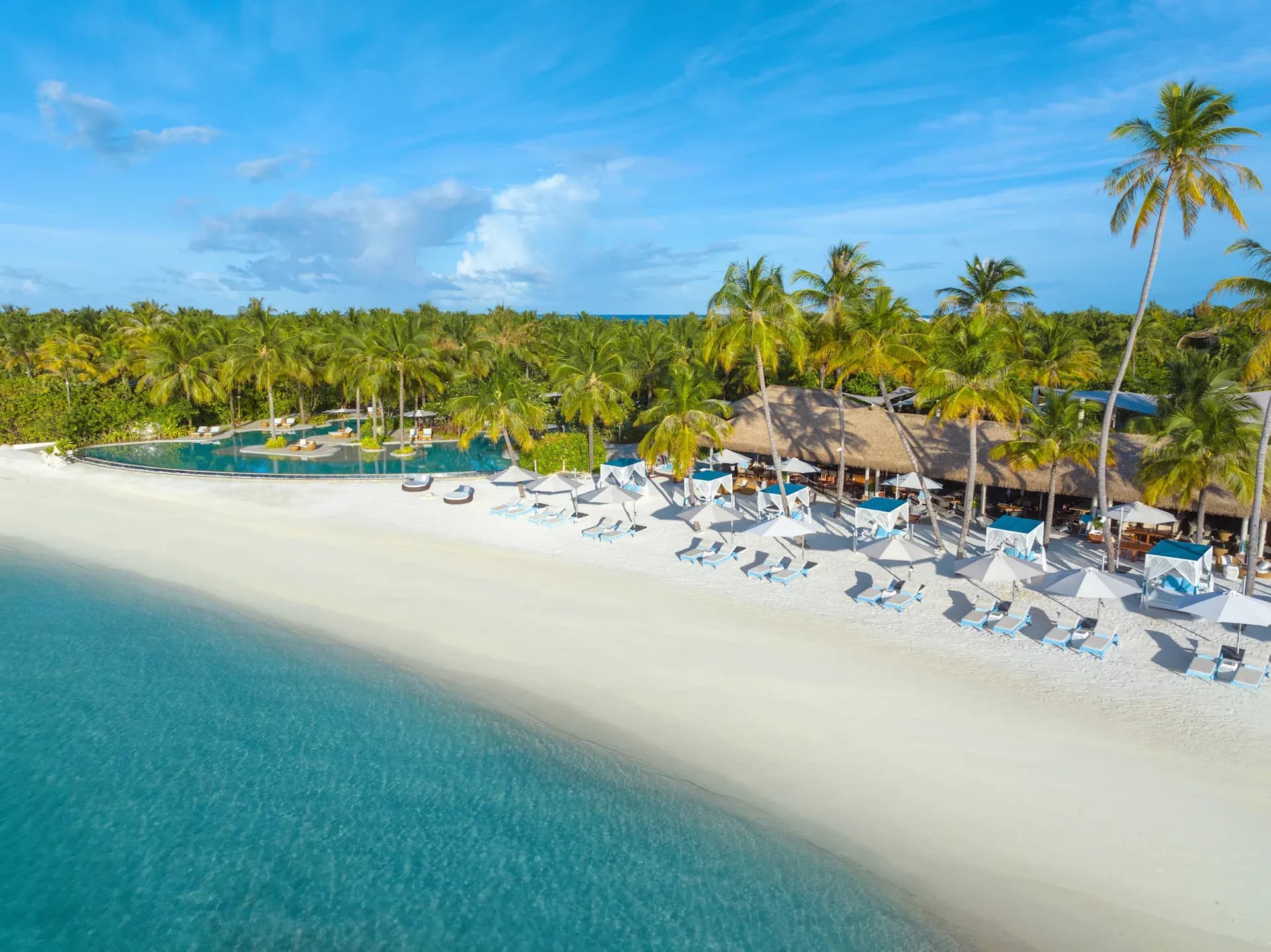 Aerial view of Nava pool and beach club at Waldorf Astoria Maldives Ithaafushi