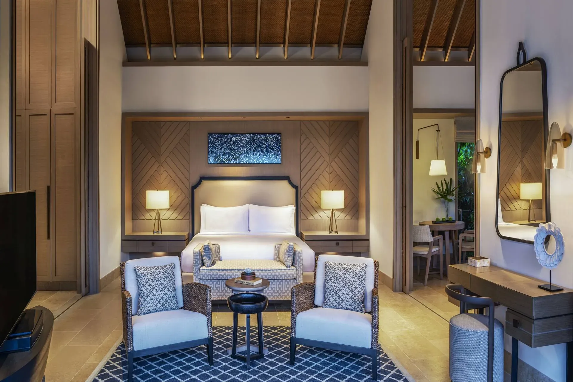 King Grand Beach Villa bedroom and living area at dusk, Waldorf Astoria Maldives Ithaafushi