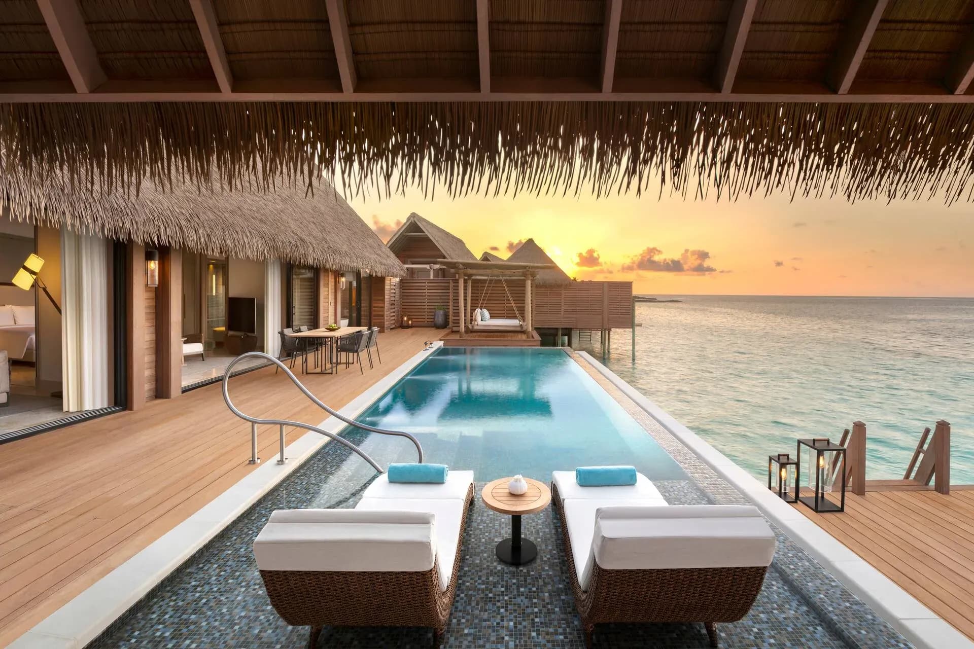King Grand Reef Villa pool deck and lounge area at dusk, Waldorf Astoria Maldives Ithaafushi