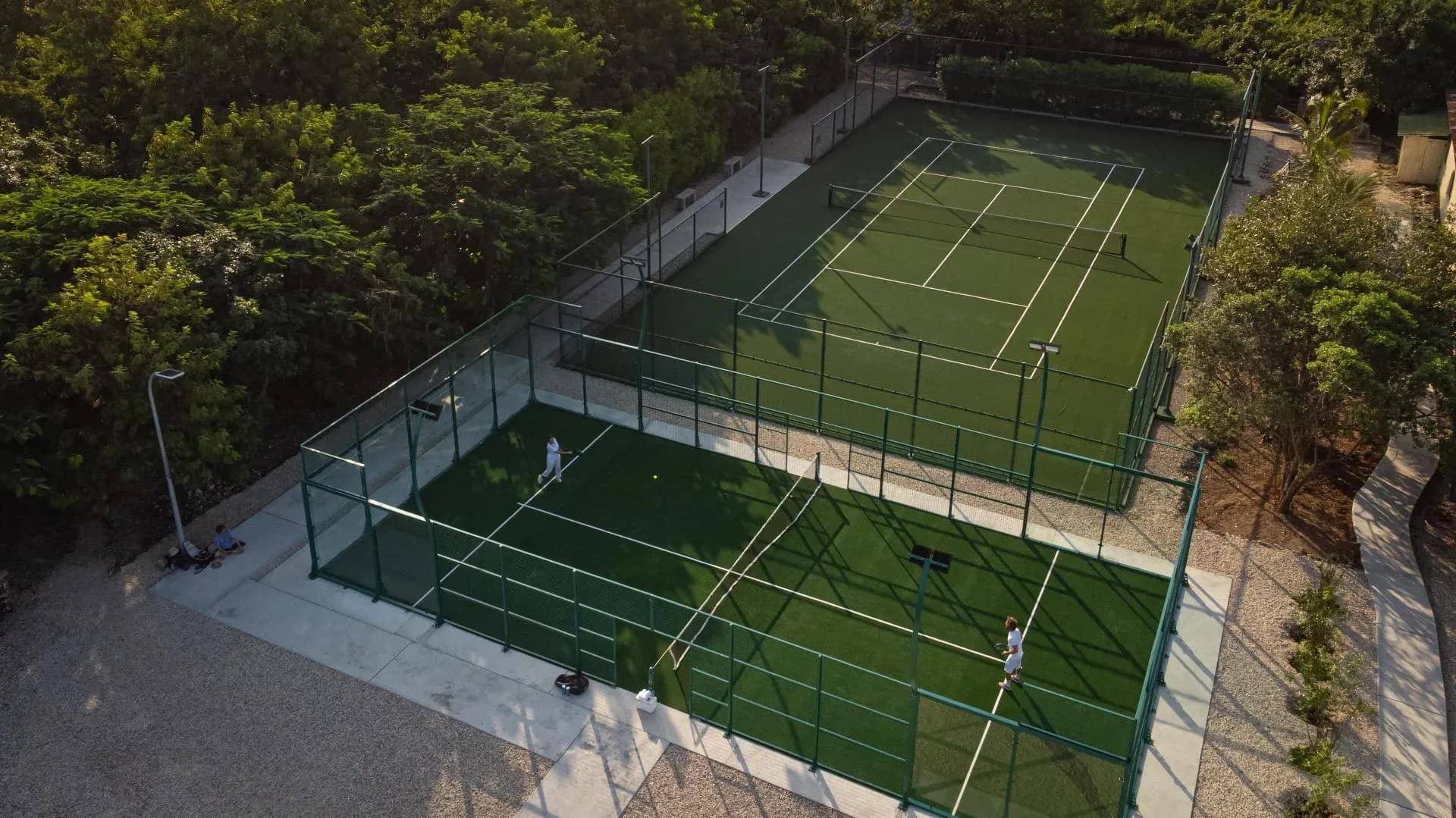 Floodlit tennis and padel courts set in tropical gardens at White Sand Luxury Villas & Spa