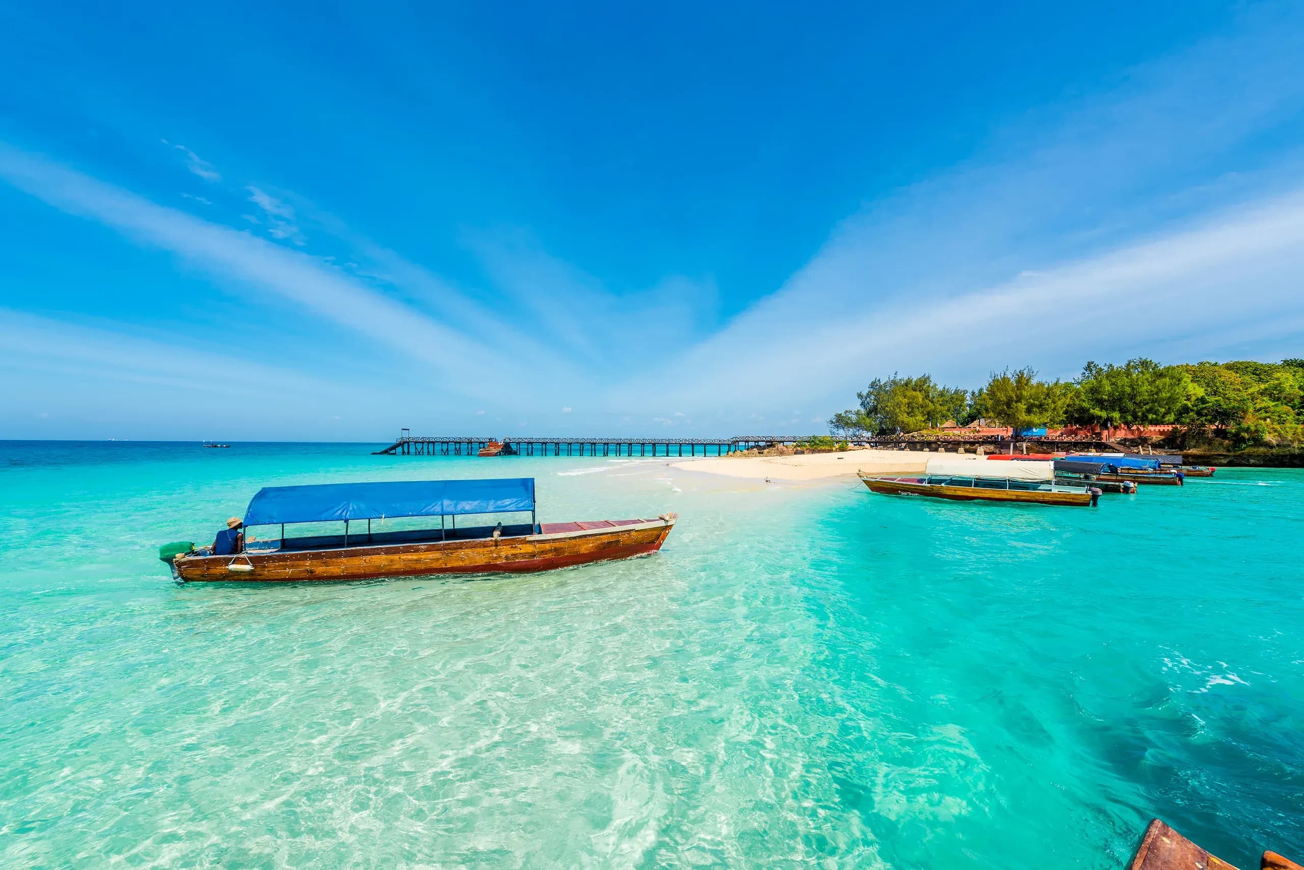 Wooden boats in the turquoise shallows off Changuu Island, Zanzibar