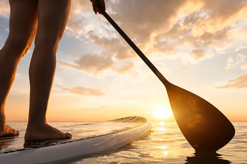 Stand-up paddleboarding at sunset with The Water Club at Zawadi Hotel Zanzibar