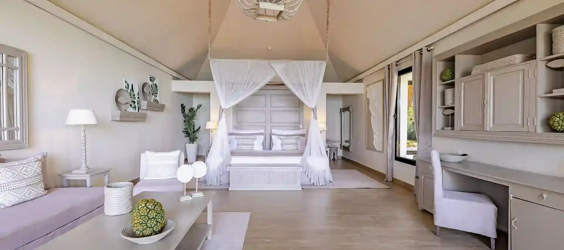 Ocean-view villa bedroom with four-poster bed at Zawadi Hotel Zanzibar